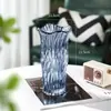 Directo del fabricante, jarrón de cristal creativo, jarrón de cristal transparente con forma de tambor de cuatro pétalos, jarrón decorativo para arreglos florales de oficina