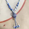 Collar con colgante de campana de mariposa de cerámica de estilo étnico retro para mujer, diseño nuevo y moderno, cadena larga para suéter, accesorios
