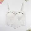 Camisola plisada con cuentas de pedrería y copas, diseñada para llevar como prenda exterior, con un diseño irregular de punta y estilo corsé de ballenas, pura y seductora