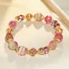 Pulsera de cuentas rosa dulce y exquisita, un accesorio claro y versátil con un toque de alta gama para el verano, adecuado para la moda de lujo ligero de uso diario