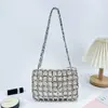 Estilo doce e cool design único senso de design bolsa de rede com rebites vazada tecida à mão bolsa de ombro único moda nicho bolsa de axila feminina