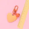 Nuevo llavero Bell love colgante lindo color resina corazón de durazno accesorios pequeño fresco adornos de corazón de durazno