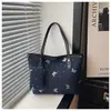 Bolsos tote de nicho populares para mujer de este año, nuevos y elegantes bolsos de hombro para el trabajo de la primavera de 2026, bolsos versátiles de axila