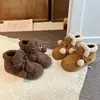 Botas Suaves y Lindas de Peluche con Lazo para Niños Cálidas 2026 Otoño/Invierno Nuevos Zapatos de Algodón Versátiles Cómodos para el Hogar
