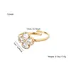 Moda Europea y Americana Lujo Accesible Circonita Incrustada Flor de Cuatro Hojas Acero Inoxidable Chapado en Oro de 18K Flor Abierta Anillo Ajustable