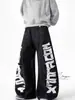 Pantalones Negros Transfronterizos con Estampado de Letras Estilo Americano, Costuras Visibles, Parches Desconstruidos, Corte Holgado, Pantalones Largos Únicos Estilo Urbano