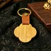 Hebilla de cuero Colgante de llavero de bambú Moderno Simple Colgante de llavero de madera en blanco Letrero con logotipo personalizado de cuero