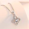 Venta caliente collar con colgante de trébol de cuatro hojas en forma de corazón de amor, colgante de circonita hueco simétrico en forma de corazón, temperamento simple de lujo ligero