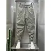 Pantalones pitillo cropped para hombre con cordón en el tobillo 2023 Verano nuevos con línea brillante overol personalizado pantalones tipo harén versátiles que estilizan