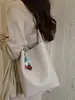 Bolsa Saco de Cor Sólida com Padrão Trançado para Mulheres Moda Verão 2026 Nova Bolsa de Mão Casual para Trabalho e Deslocamento Bolsa de Ombro