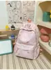 Mochila pequeña, simple, de color sólido con bordado de letras texturizado, diseñada para estudiantes mujeres, adecuada para la escuela y el uso diario, ligera y reduce la carga en los hombros