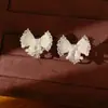 Aretes de clip para orejas con diseño de lazo de gota de aceite de circón para mujer sin perforaciones, aretes versátiles y elegantes, sensación de lujo ligero y alta gama, venta al por mayor