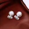 Pendientes de borla con flor de trébol de circonita vintage con un toque de alta gama, pendientes versátiles y de moda al por mayor