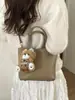 Bolsa Balde de Mão com Design de Nicho Estilo Coreano para Mulheres Nova Moda Primavera 2026 Bolsa de Ombro Transversal Simples e Elegante