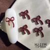 Nuevos accesorios de arte de uñas con pintura en aerosol de aleación, accesorios de arte de uñas de la suerte de Año Nuevo rojo de otoño e invierno, lazos huecos conjoined