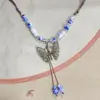 Collar con colgante de campana de mariposa de cerámica de estilo étnico retro para mujer, diseño nuevo y moderno, cadena larga para suéter, accesorios