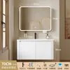 Tocador de baño engrosado y ahorrador de espacio con diseño en color crema, que cuenta con un lavabo redondeado, lavabo cerámico integrado y un lavabo de una sola pieza.