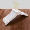 Percha de tienda de ropa sin costuras al por mayor de plástico blanco antideslizante percha con pinza para abrigos de mujer soporte para ropa de niños LOGOTIPO