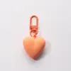 Llavero de corazón de melocotón nuevo color caramelo amor funda protectora aipods funda para auriculares colgante adornos para bolso