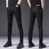 Jeans negros puros de alta gama Hong Kong 2026, elásticos, corte slim para hombre, pantalones casuales versátiles estilo coreano