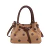 Bolso de mano de lunares de moda estilo coreano, bolso tipo cubo de PU para mujer, nuevo modelo 2026, bolso de hombro y cruzado de moda para el día a día.