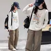 Ropa interior para niñas Otoño Manga larga 2026 Nueva camiseta Niños Estilo coreano Holgada Mediana y Grande Moda infantil Top de dibujos animados