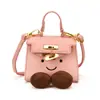 Nuevo bolso de mano de dibujos animados con cara sonriente para otoño e invierno, un mini bolso Kelly de alta gama con bloques de color, un bolso pequeño elegante y versátil para padres e hijos