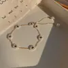 Pulsera de perlas vintage de Corea del Sur estilo ins femenino nicho pulsera de acero de titanio pulsera de pareja joyería de mano venta al por mayor