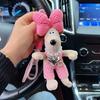 Pantalones de tirantes lindos de dibujos animados Llavero de perro popular Llavero de coche de pareja Colgante de bolso con nudo de lazo dulce