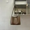 Bolsa estilo coreano retrô com textura trançada, modelo bucket, nova coleção verão 2026, simples e elegante, para uso diário, de ombro ou axila.
