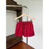 Minifalda retro americana de chica caliente, color rojo dopamina con cordón, nueva falda bodycon de cintura alta versátil y adelgazante para el verano