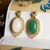 Colgante de huevo de jade dorado de Xinjiang con superficie de lujo con incrustaciones de jade Dongling Colgante de jade Regalo Joyería Venta al por mayor
