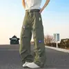 Jeans workwear verde militar com bordado floral retrô americano, multi-bolsos, perna larga solta, comprimento até o chão, para outono e inverno