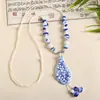 Collar con colgante de campana de mariposa de cerámica de estilo étnico retro para mujer, diseño nuevo y moderno, cadena larga para suéter, accesorios