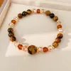 Pulsera de cuentas de ojo de tigre, sensación de lujo ligero de nicho de alta gama, accesorio de mano versátil estilo Maillard