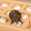 Venta al por mayor té de primavera de material puro de árbol antiguo té Pu'er té Pu'er crudo en caja té Pu'er Tuo bola de dragón hecha a mano