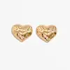 Accesorios transfronterizos europeos y americanos: Pendientes sencillos y elegantes estilo ins de flor y corazón, versátiles pendientes metálicos de estrella de mar lisa de lava