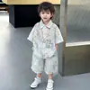 Conjunto de Camisa Floral de Manga Corta para Niños Verano 2026 Nueva Moda Estilo Hong Kong Fresco Joven Caballero Atuendo de Vacaciones Playa