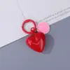 Llavero de corazón grande de color sólido de doble cara con cara sonriente, cara sonriente curativa, accesorio de llave para bolso simple y versátil venta al por mayor