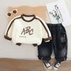 Primavera 2025 para niños Primavera y Otoño Nuevo Conjunto de dos piezas de sudadera de cuello redondo con letras para niño Pantalones de mezclilla para bebé