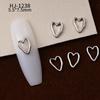 Nuevos accesorios de aleación para decoración de uñas con forma de corazón torcido tridimensional liso con diseño de amor hueco retro japonés