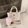 Bolso Cubo Estilo Japonés y Coreano con Estampado de Dibujos Animados para Mujer 2026 Nueva Moda Bolso de Hombro Cruzado Versátil para Viajes Casuales
