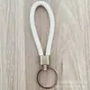 Llavero de cuerda de cuero trenzado simple creativo colgante de muñeca linda accesorios de llave para parejas tendencia regalos pequeños venta al por mayor