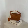 La popular bolsa versátil de diseño de nicho transfronterizo de este año, bolso de mano, bolso de hombro, bolso de hombro y bandolera versátil estilo coreano tipo dumpling