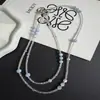 Lujo ligero sensación de alta gama cristal iridiscente azul claro cuenta cadena cruzada para teléfono llavero de diseño creativo bolsa cadena larga