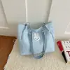 A bolsa tote doce popular deste ano para mulheres é o novo modelo de outono de 2026 com enfeites de estrela, adequada para o trabalho e como bolsa de ombro.