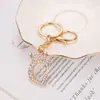 Chaveiro de Letra Inglesa 26 Cravejado com Diamantes Venda Quente Transfronteiriça Estilo Fashion para Casal Mochila Escolar de Estudante Pingente de Liga de Zinco com Diamante Flash