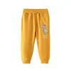 Moda Casual 26 Años Pantalones Deportivos Infantiles Estampado de Dinosaurio de Dibujos Animados Otoño e Invierno Pantalones Largos para Niños Pequeños y Medianos En Stock