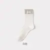 Calcetines apilados de tela estilo Miu con puños de canalé doble, etiqueta de tela de color liso, calcetines de algodón versátiles para mujer, calcetines casuales versátiles estilo universitario