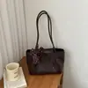 Bolso de mano de alta gama transfronterizo, elegante nuevo modelo de verano 2026, popular bolso de hombro versátil con patrón tejido, bolso tote